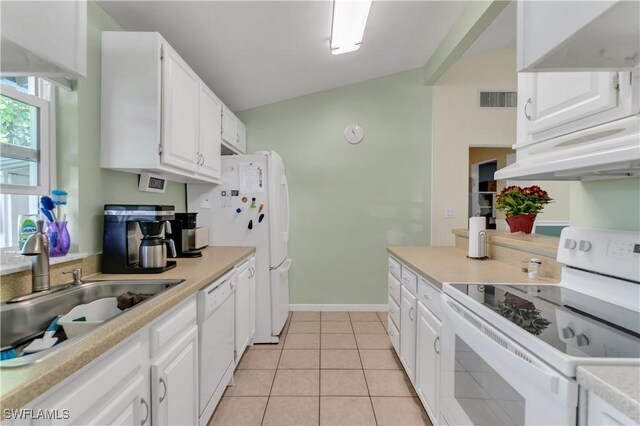 kitchen featuring white cabinetry, sink, vaulted ceiling, white appliances, and light tile patterned floors