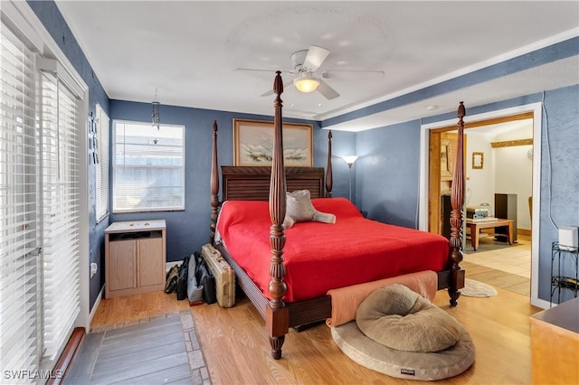 bedroom with hardwood / wood-style floors and ceiling fan