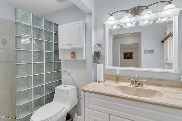 bathroom featuring a shower, vanity, and toilet