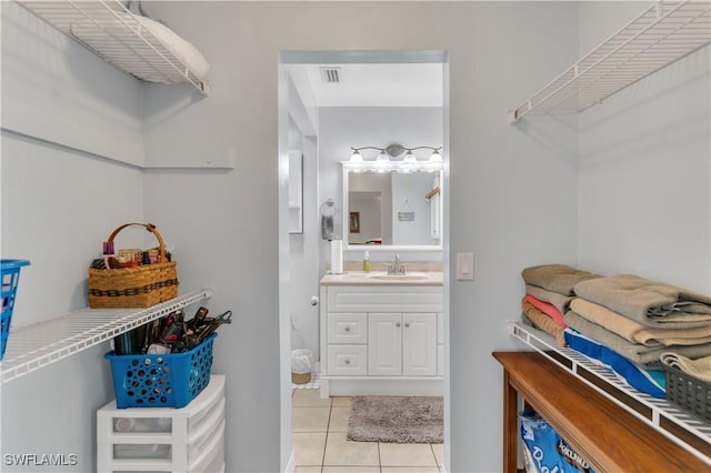 bathroom with tile patterned flooring and vanity