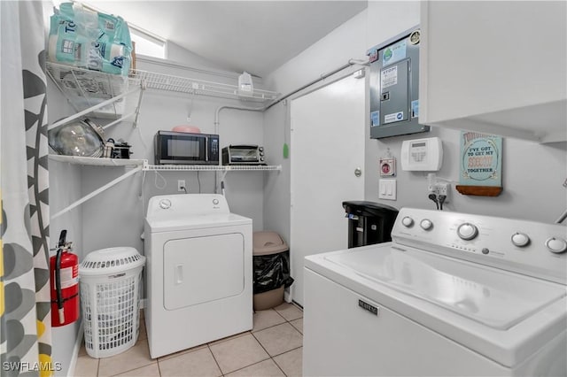 washroom with washing machine and dryer and light tile patterned floors