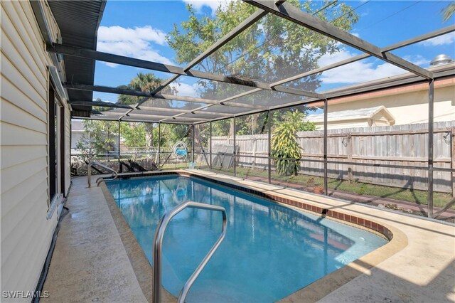 view of swimming pool with a lanai