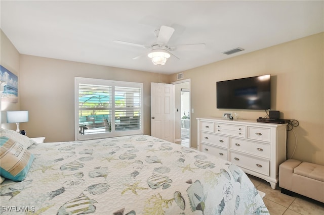 tiled bedroom featuring ceiling fan