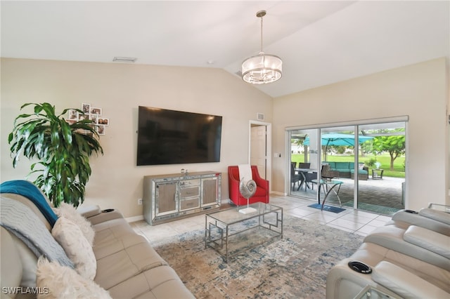 living room featuring a notable chandelier, light tile patterned flooring, and lofted ceiling