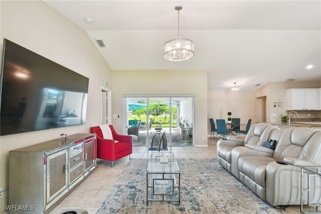 living room with light tile patterned floors, lofted ceiling, and an inviting chandelier