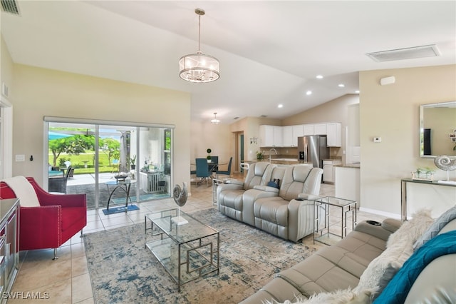 tiled living room featuring sink, a chandelier, and lofted ceiling