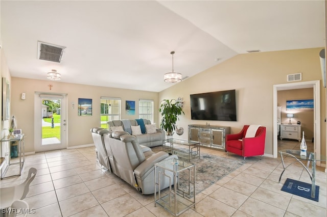 living room with light tile patterned floors, vaulted ceiling, and an inviting chandelier