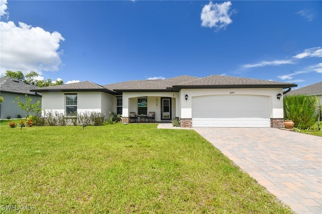 view of front of home with covered porch, a garage, and a front lawn