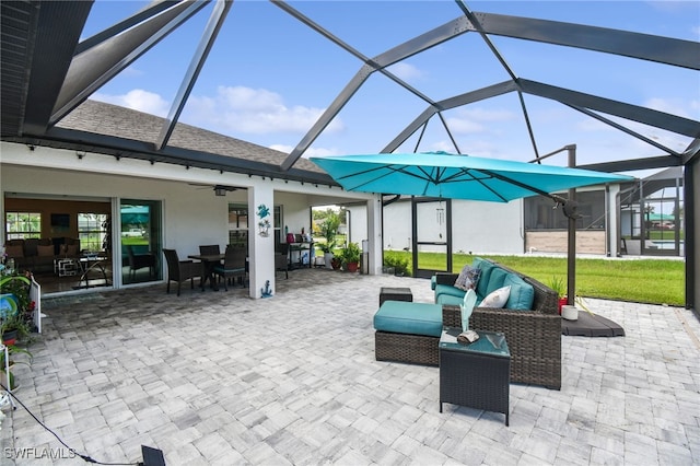 view of patio / terrace with a lanai, outdoor lounge area, and ceiling fan