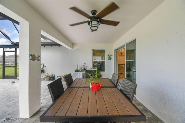 view of patio with ceiling fan and a lanai