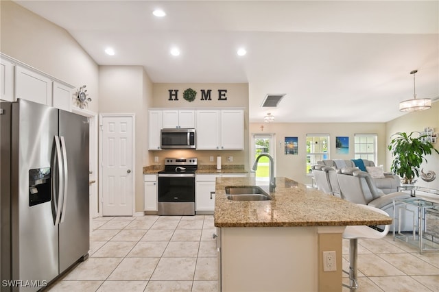 kitchen with white cabinetry, sink, an island with sink, decorative light fixtures, and appliances with stainless steel finishes