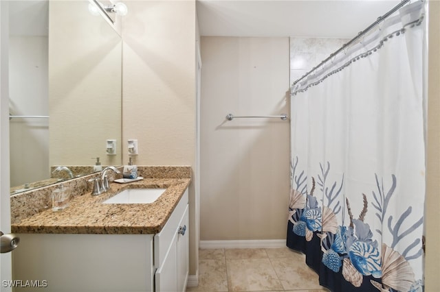 bathroom featuring tile patterned flooring and vanity