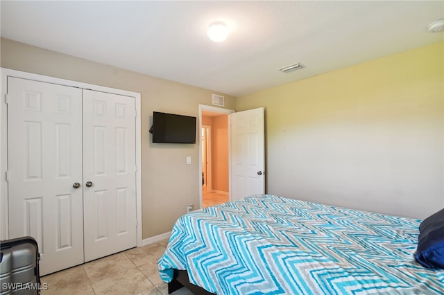 tiled bedroom featuring a closet