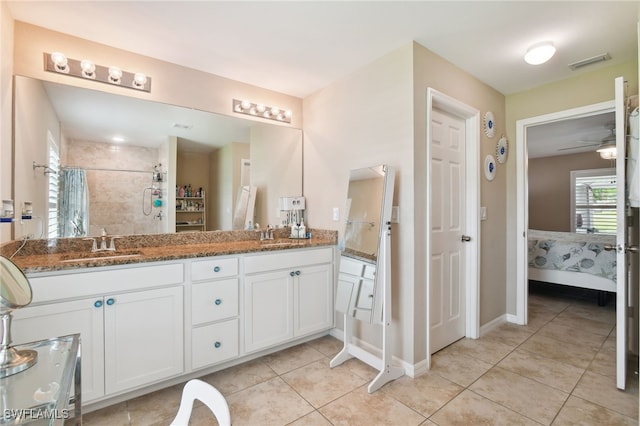 bathroom with tile patterned flooring, a shower with curtain, vanity, and ceiling fan