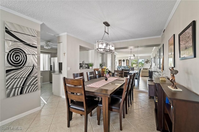 dining room featuring ceiling fan with notable chandelier, light tile patterned flooring, ornamental molding, and a textured ceiling