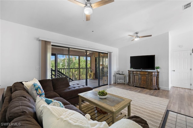 living room with vaulted ceiling and light hardwood / wood-style flooring