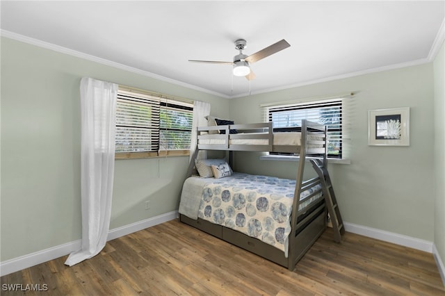 bedroom with ceiling fan, dark wood-type flooring, and multiple windows