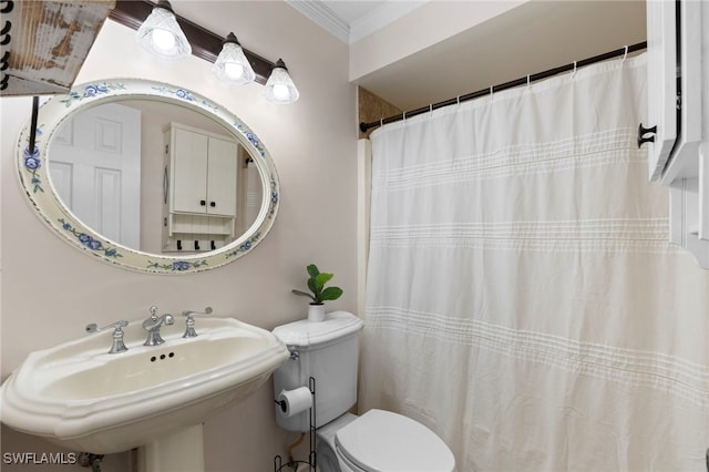 bathroom with toilet, crown molding, sink, and walk in shower