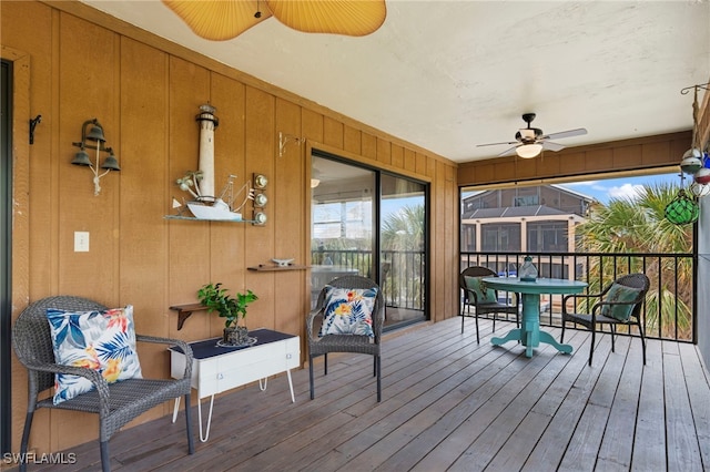 wooden deck featuring ceiling fan