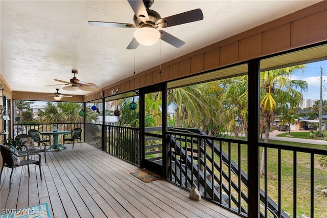 wooden terrace featuring ceiling fan