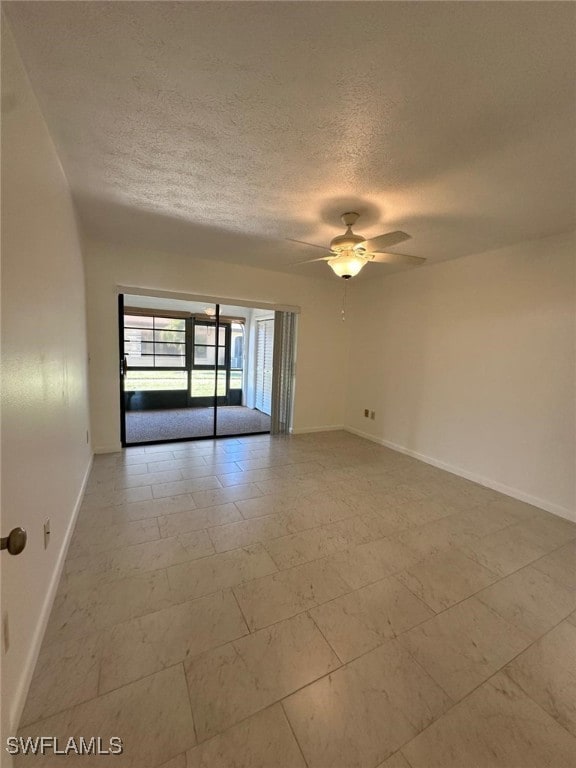 unfurnished room featuring a textured ceiling and ceiling fan