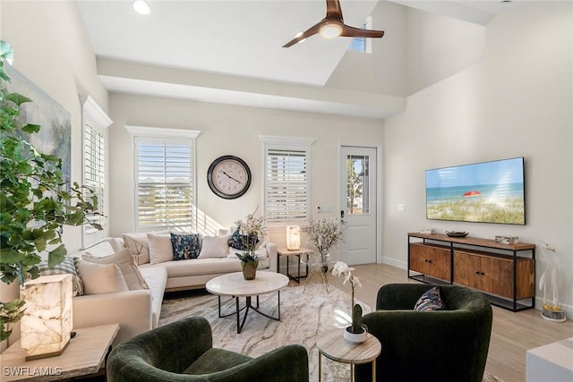 living room with light hardwood / wood-style floors and ceiling fan