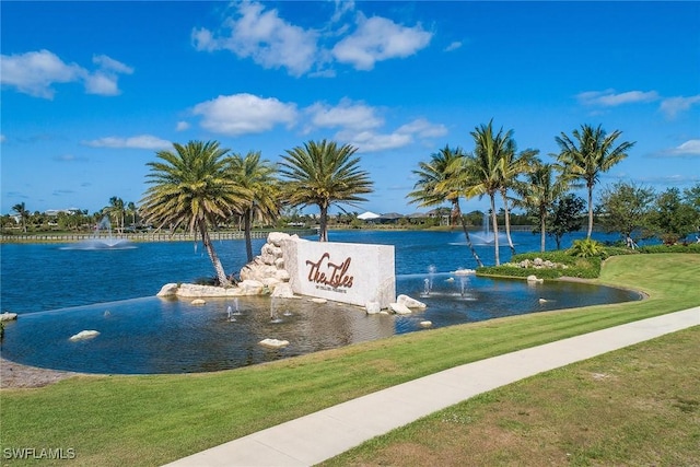 exterior space featuring a lawn and a water view