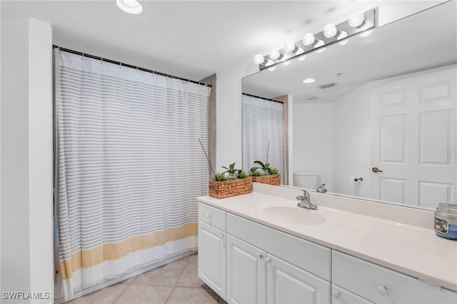 bathroom featuring tile patterned flooring, vanity, toilet, and a shower with curtain