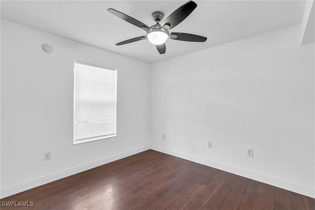 empty room featuring dark hardwood / wood-style flooring and ceiling fan