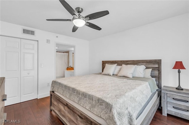 bedroom with dark hardwood / wood-style floors, ceiling fan, and a closet