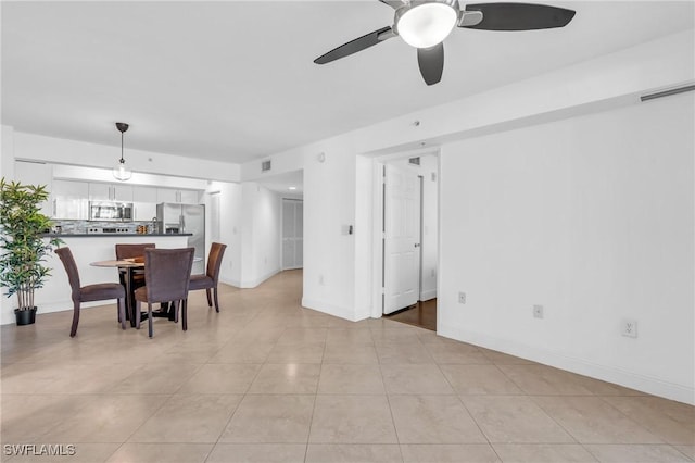 dining area with light tile patterned floors and ceiling fan