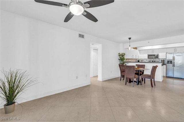 dining room featuring ceiling fan and light tile patterned floors