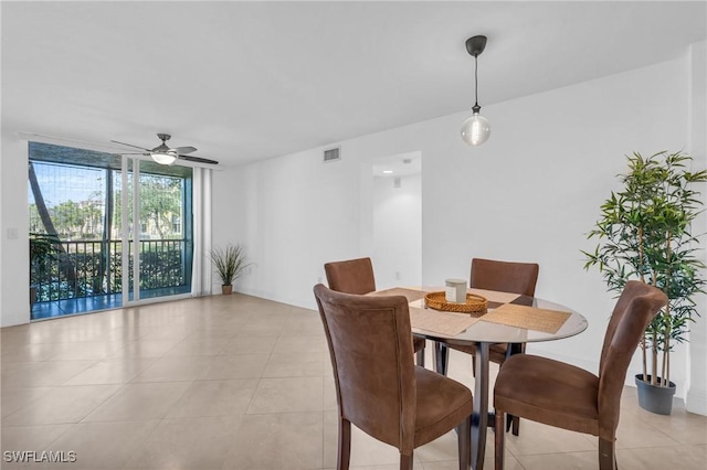 dining space with ceiling fan and light tile patterned floors