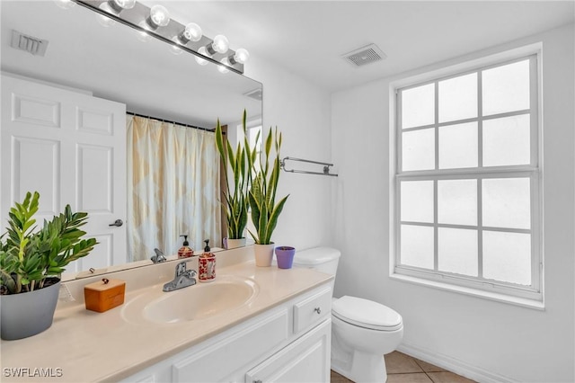 bathroom with tile patterned floors, vanity, and toilet