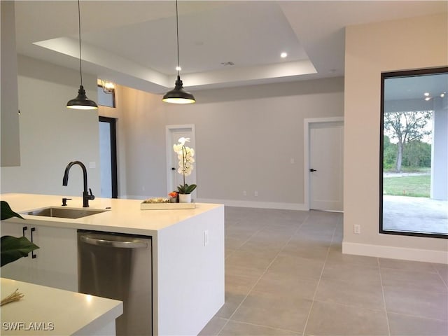 kitchen with sink, hanging light fixtures, a raised ceiling, stainless steel dishwasher, and light tile patterned floors