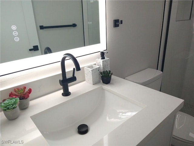 bathroom with vanity and toilet