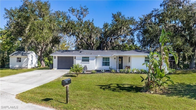 ranch-style house featuring a storage unit, a garage, and a front lawn