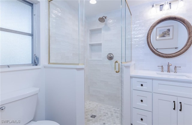 bathroom with vanity, toilet, and an enclosed shower