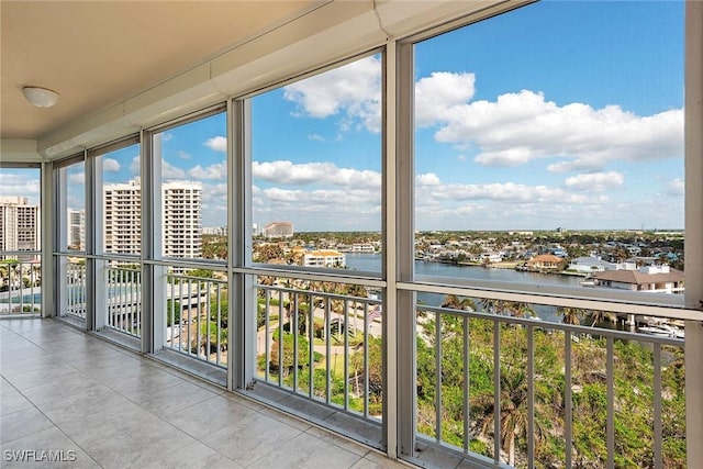 unfurnished sunroom featuring a water view