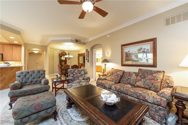 living room featuring crown molding, wood-type flooring, and ceiling fan with notable chandelier