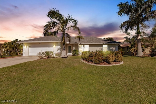 single story home featuring a yard and a garage