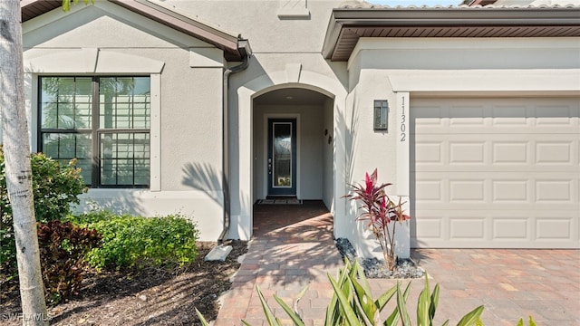 doorway to property with a garage