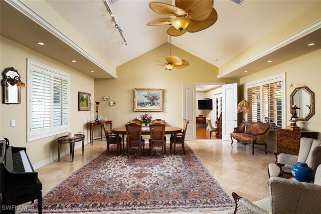 dining space featuring rail lighting, plenty of natural light, lofted ceiling, and ceiling fan