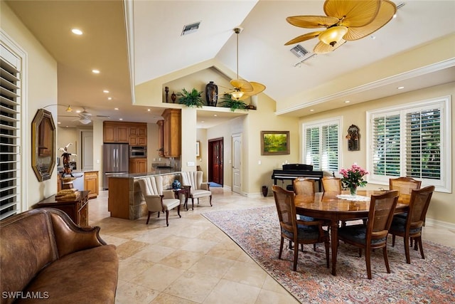 dining space with high vaulted ceiling and ceiling fan