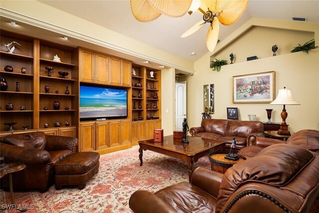 living room featuring lofted ceiling, built in shelves, and ceiling fan