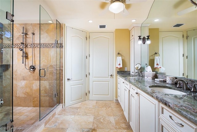 bathroom featuring walk in shower, ceiling fan, and vanity