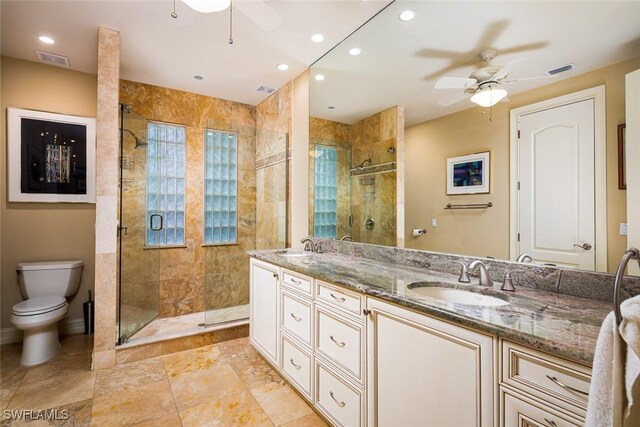 bathroom with vanity, ceiling fan, and walk in shower