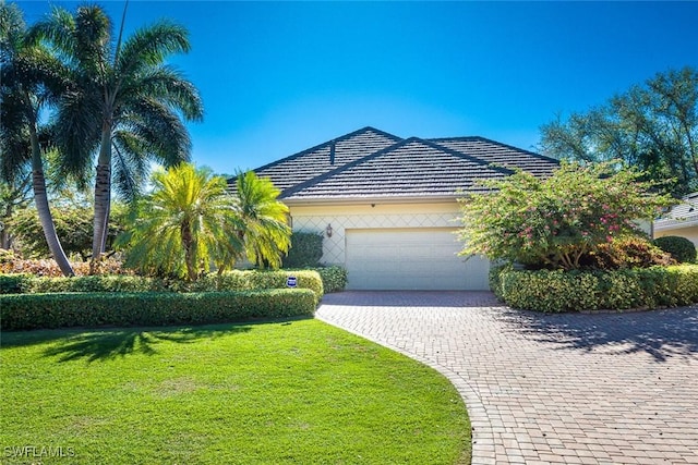 view of front of home with a garage and a front yard