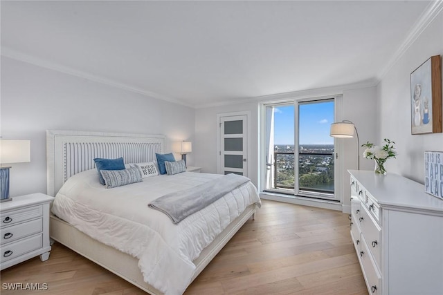 bedroom with ornamental molding and light hardwood / wood-style floors