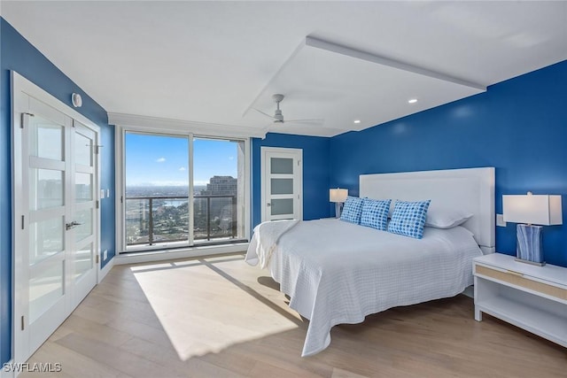 bedroom featuring floor to ceiling windows and light wood-type flooring